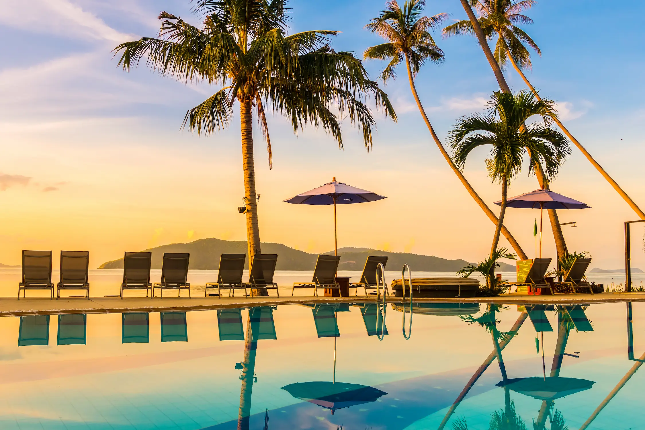 beautiful-outdoor-view-with-umbrella-chair-around-swimming-pool-luxury-hotel